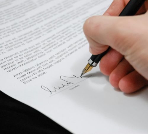person signing in documentation paper